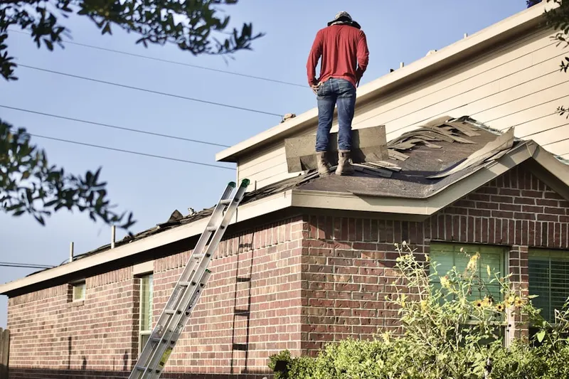 Professional roofer working on a residential roof in Shrub